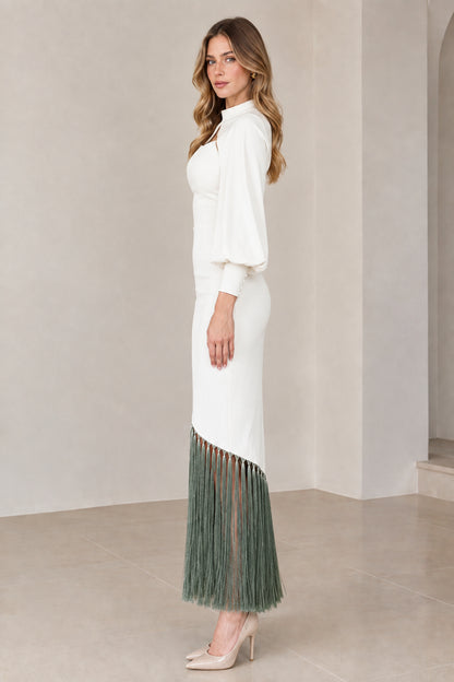 Side profile of white and sage green cape sleeve fringe hem midi dress