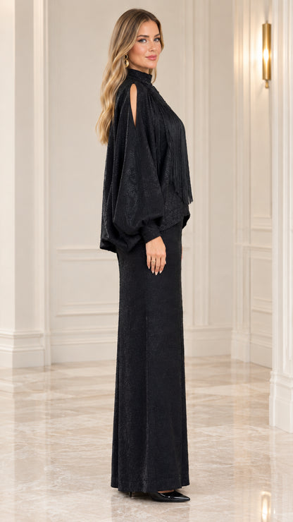 Side profile of model wearing black two-piece maxi set with cold-shoulder sleeves