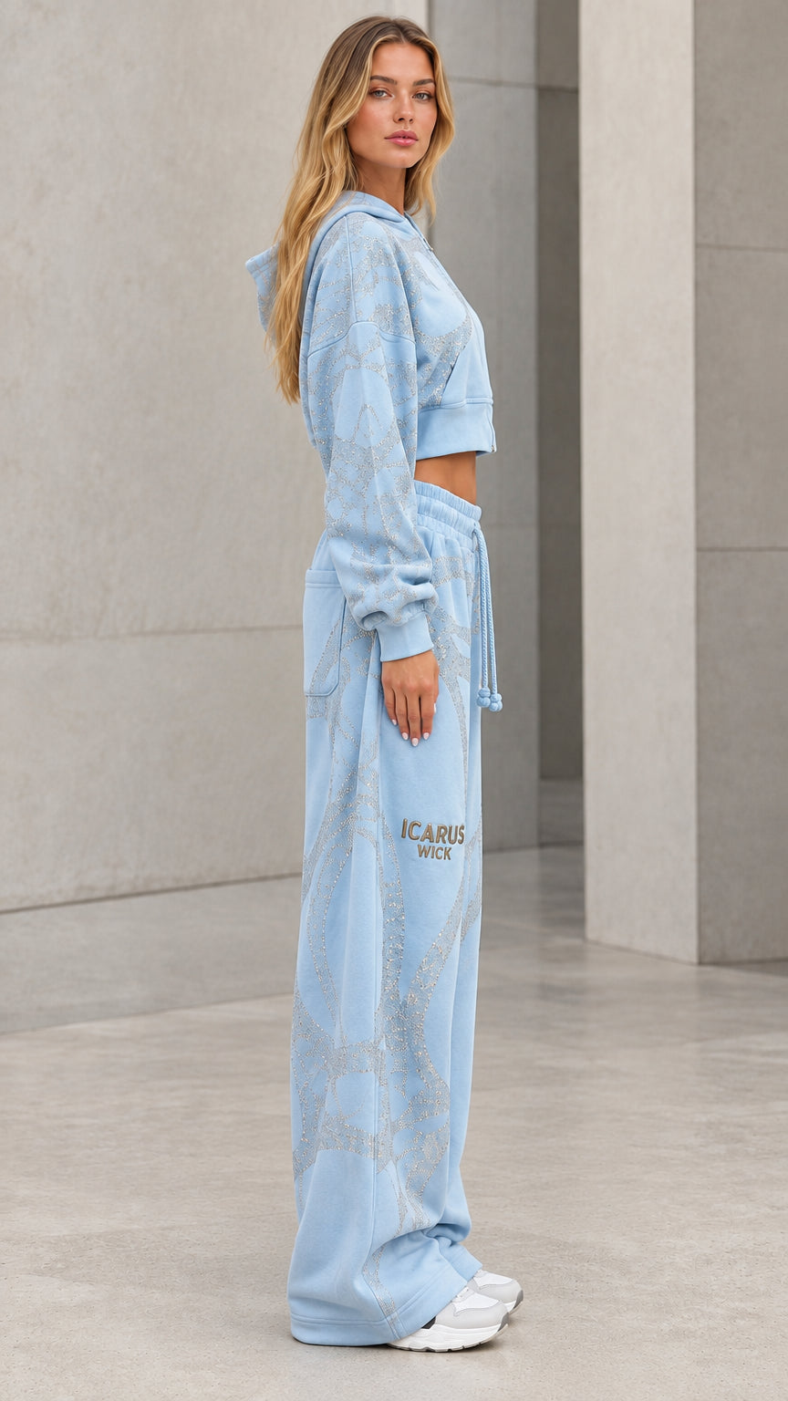 Side profile view of model in light blue two-piece glitter tracksuit set