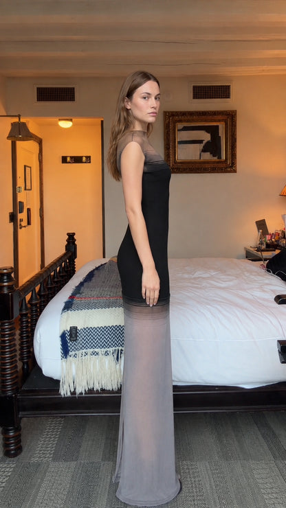 Side profile view of model in black illusion mesh maxi dress