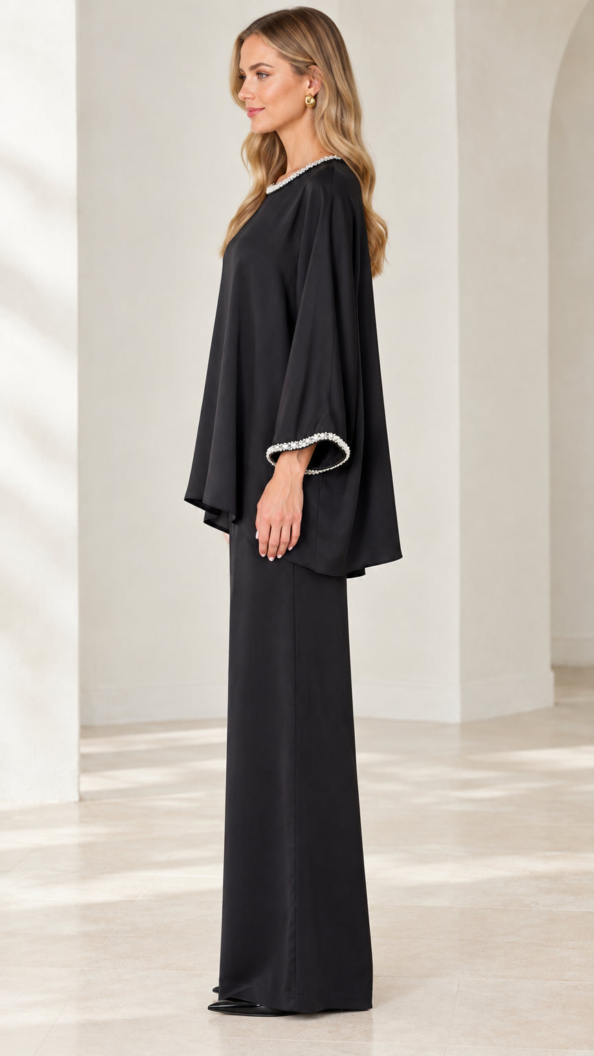 Side view of woman in Black matching tunic and wide trousers set
