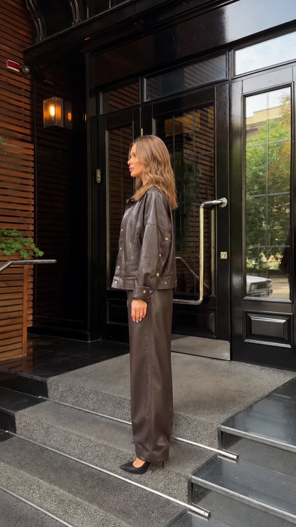 Side profile view of woman modeling dark brown faux leather matching two-piece set