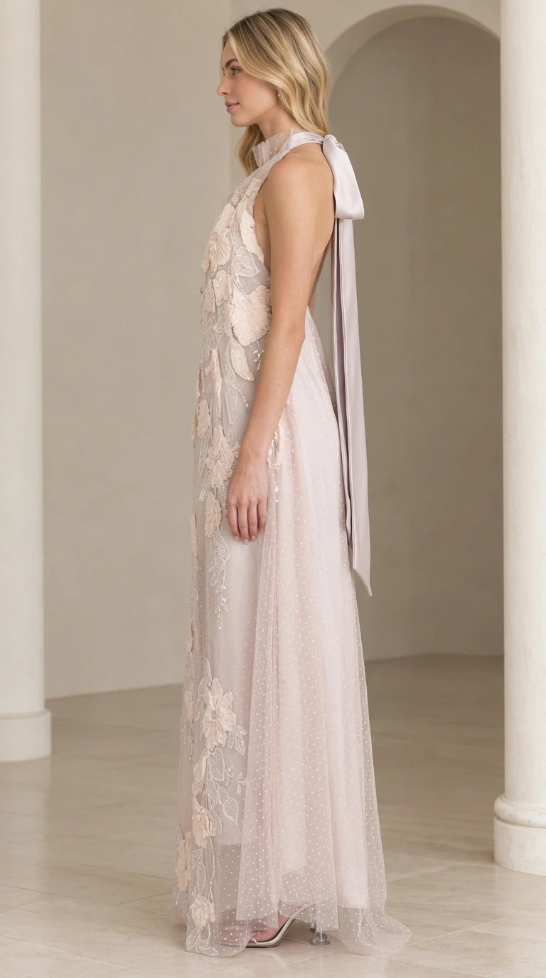 Side profile of woman in dusty lilac floral lace gown showcasing back ribbon tie