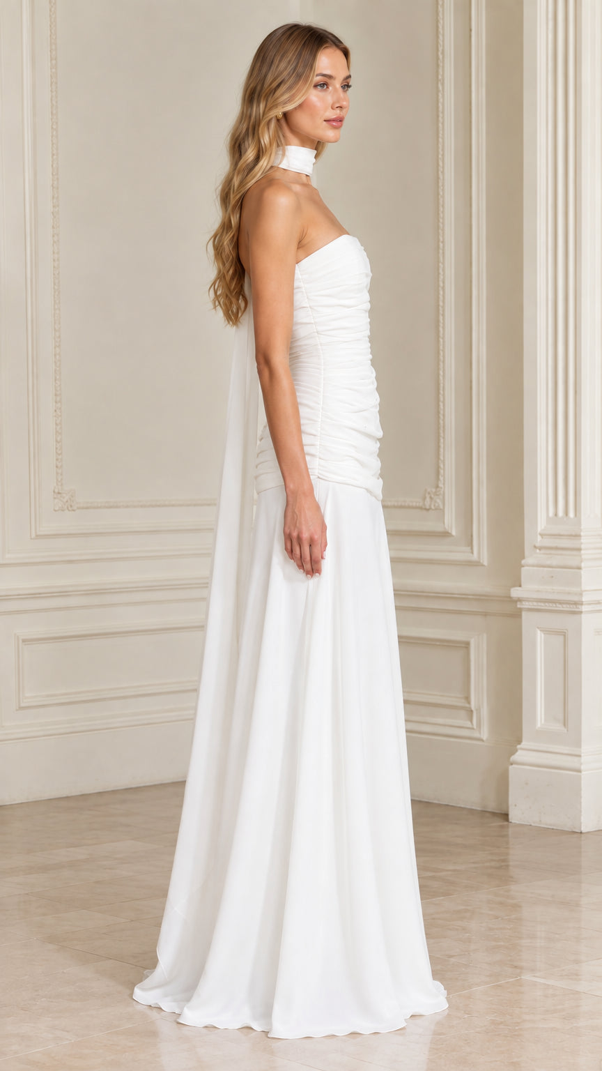 Side view of model wearing white strapless ruched formal dress