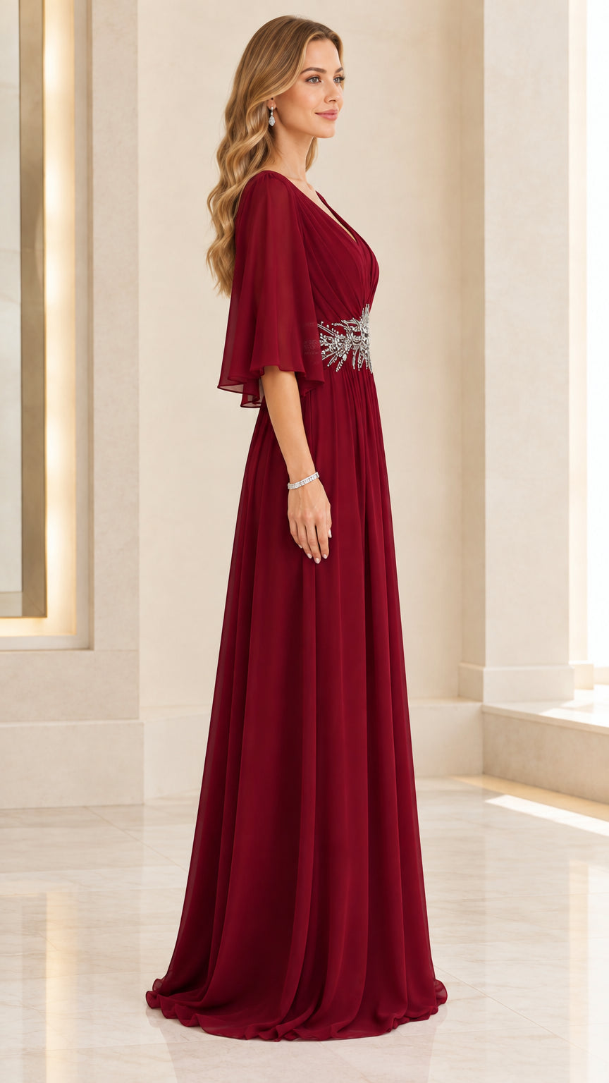 Side profile view of woman modeling floor-length burgundy chiffon formal dress