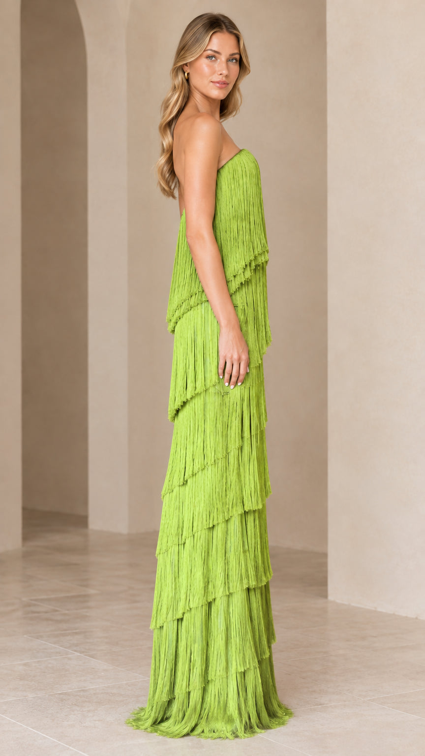 Side full-length view of lime green strapless fringe evening gown