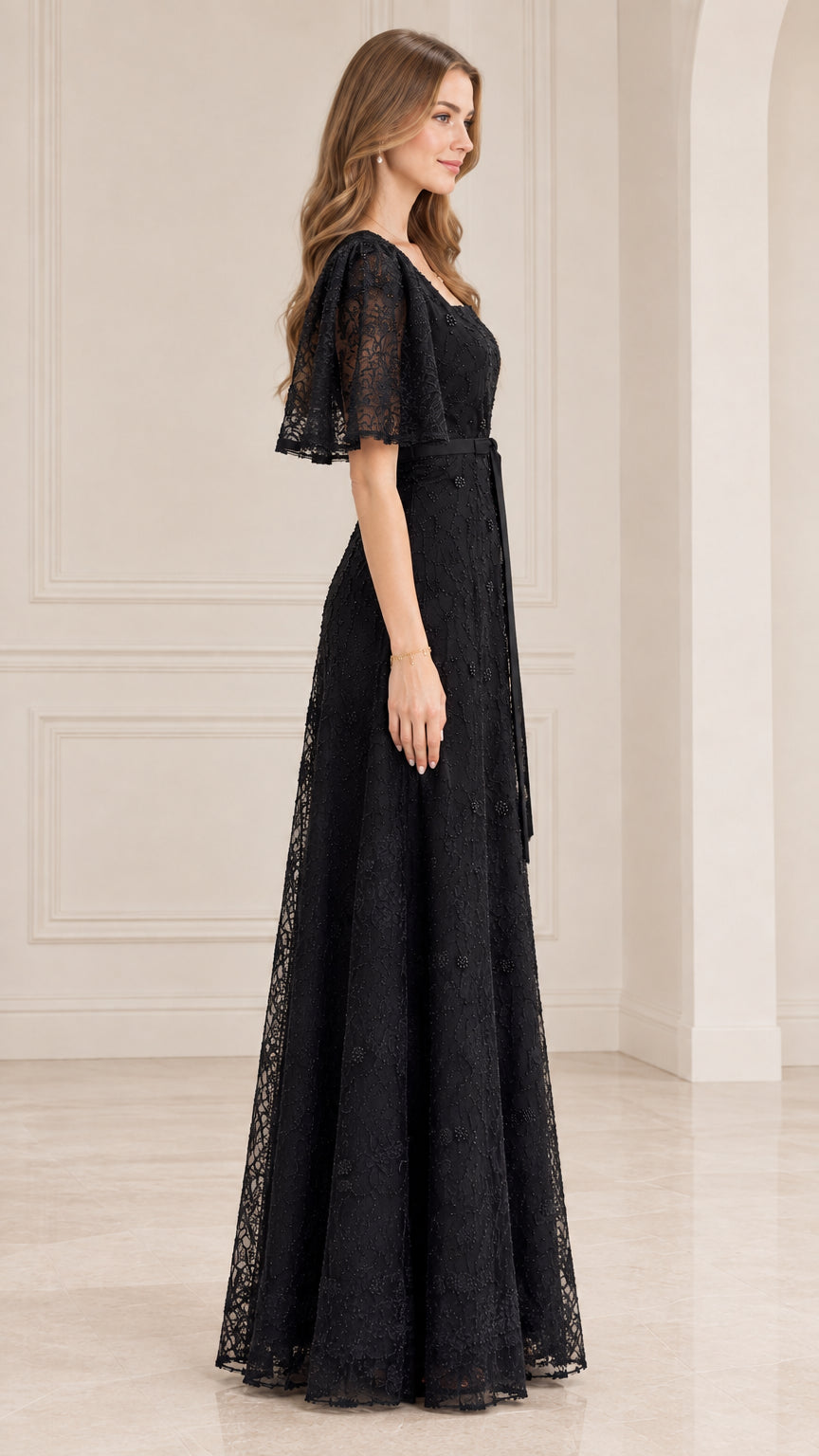Side view of model wearing black embroidered lace evening gown