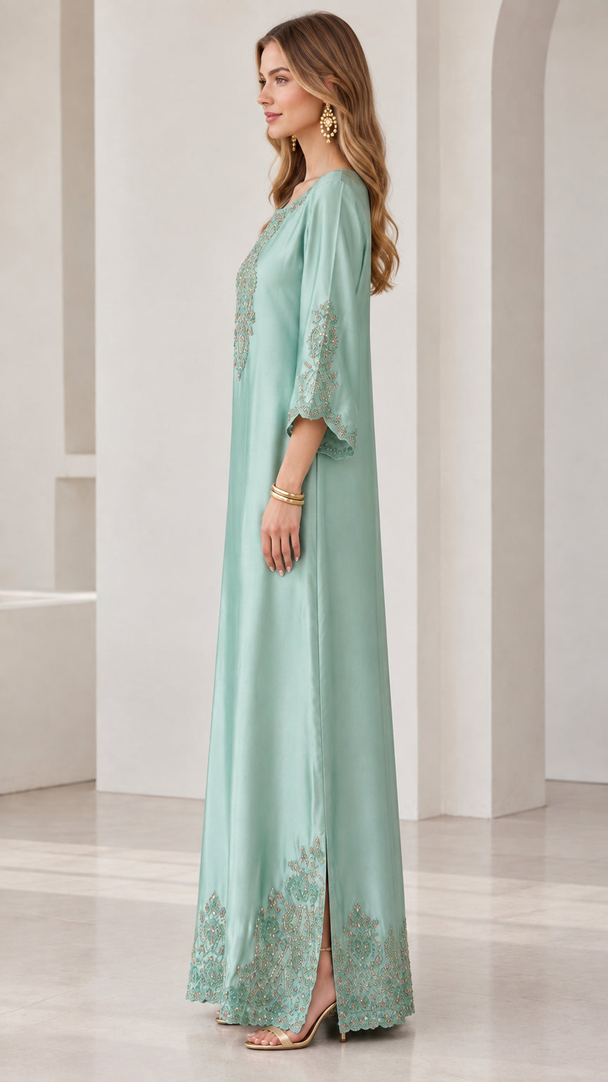 Side profile view of mint green satin kaftan dress showing drape and side slit