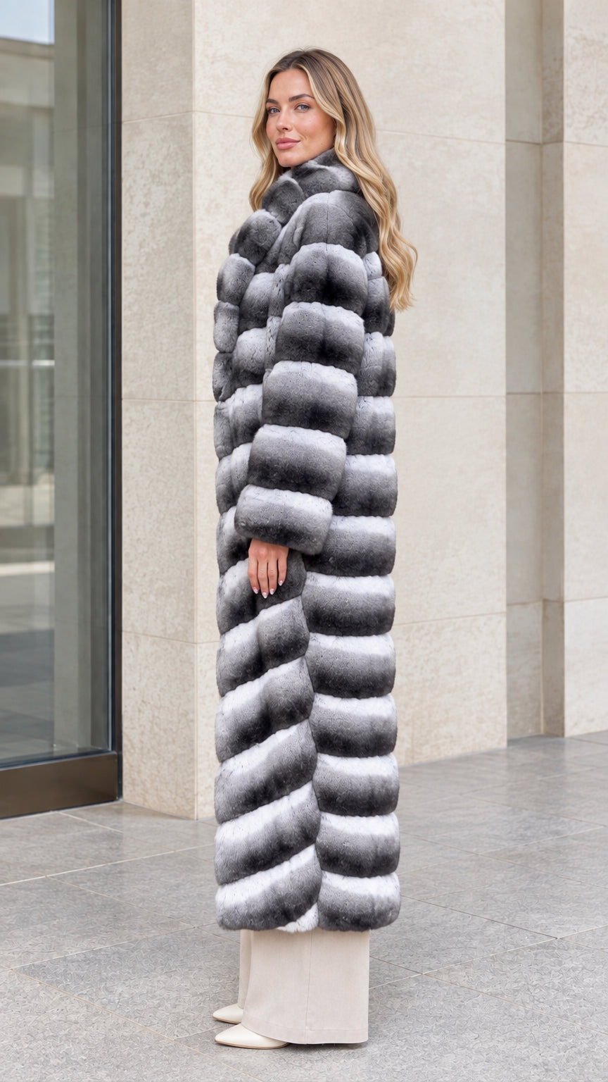 Side profile view of full-length Grey Ombre tiered faux fur coat