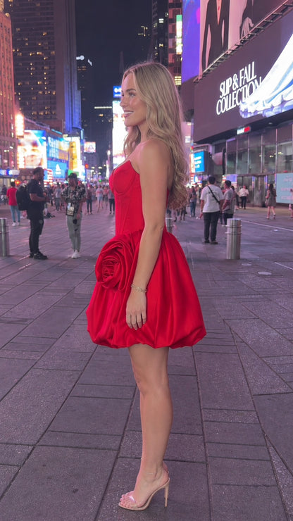 Side profile of red strapless rosette bubble mini dress
