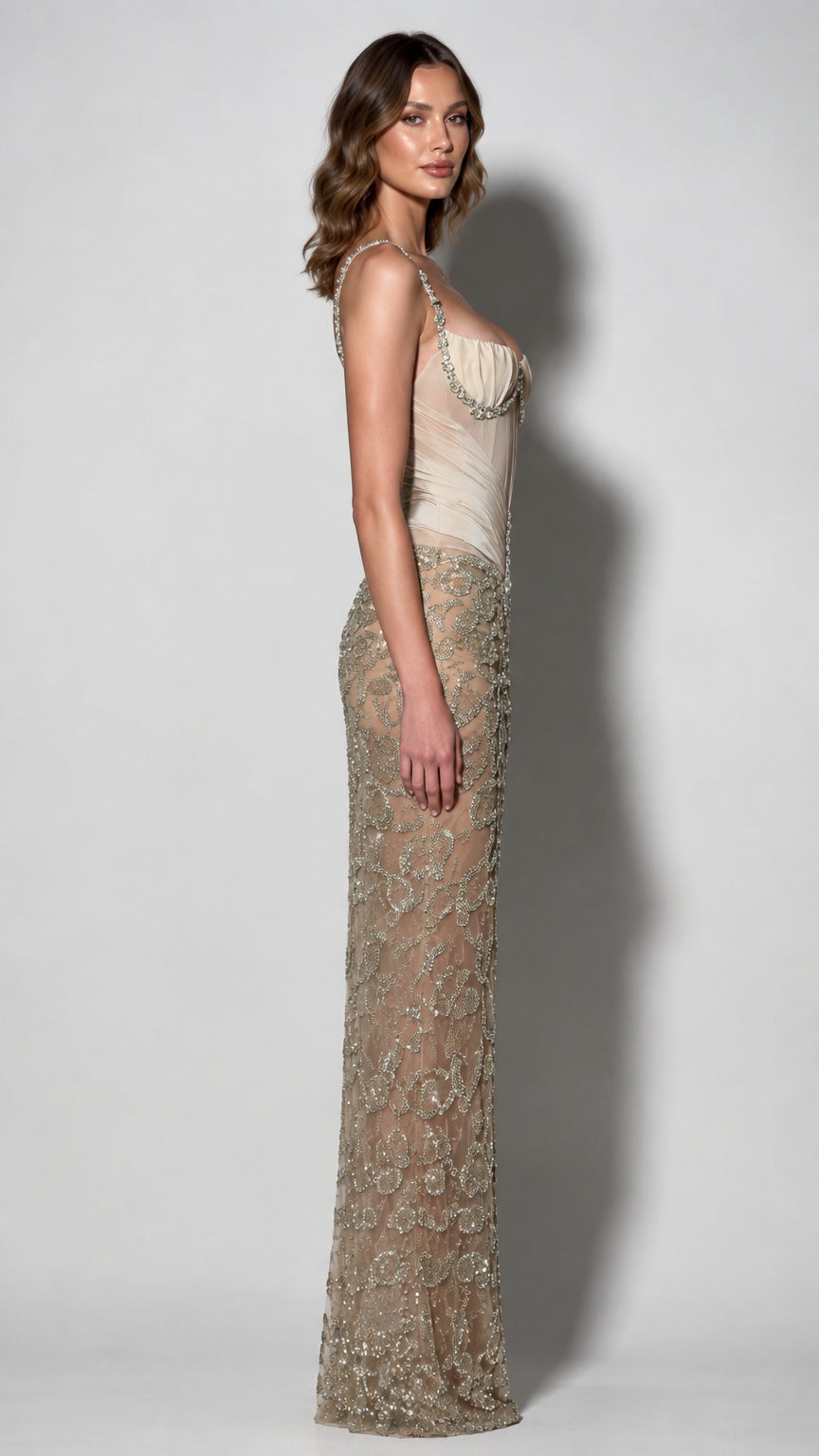 Side profile view of champagne beaded corset formal dress