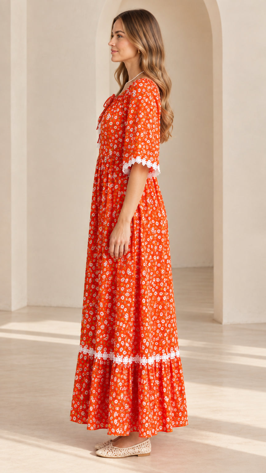 Side profile of model in rust orange boho floral maxi dress