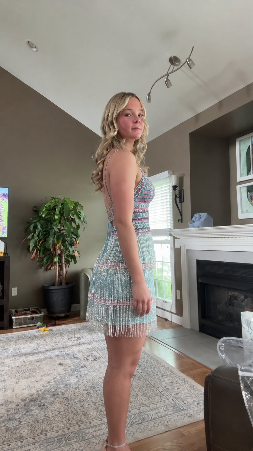 Side profile of aqua blue fringe mini party dress with delicate straps