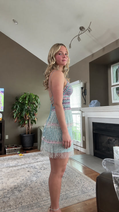 Side profile of aqua blue fringe mini party dress with delicate straps