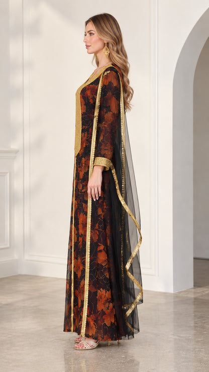 Side profile of model in black floral kaftan dress highlighting draped cape overlay