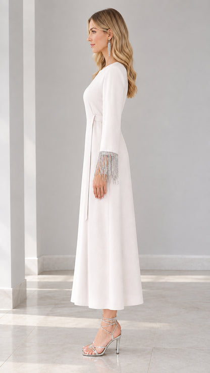 Side profile of white maxi dress with fringe sleeves and waist tie