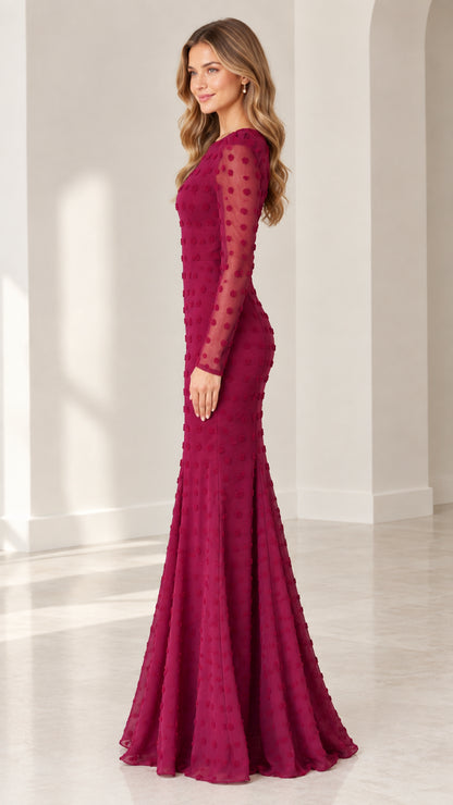 Side profile view of burgundy textured dot floor-length formal dress