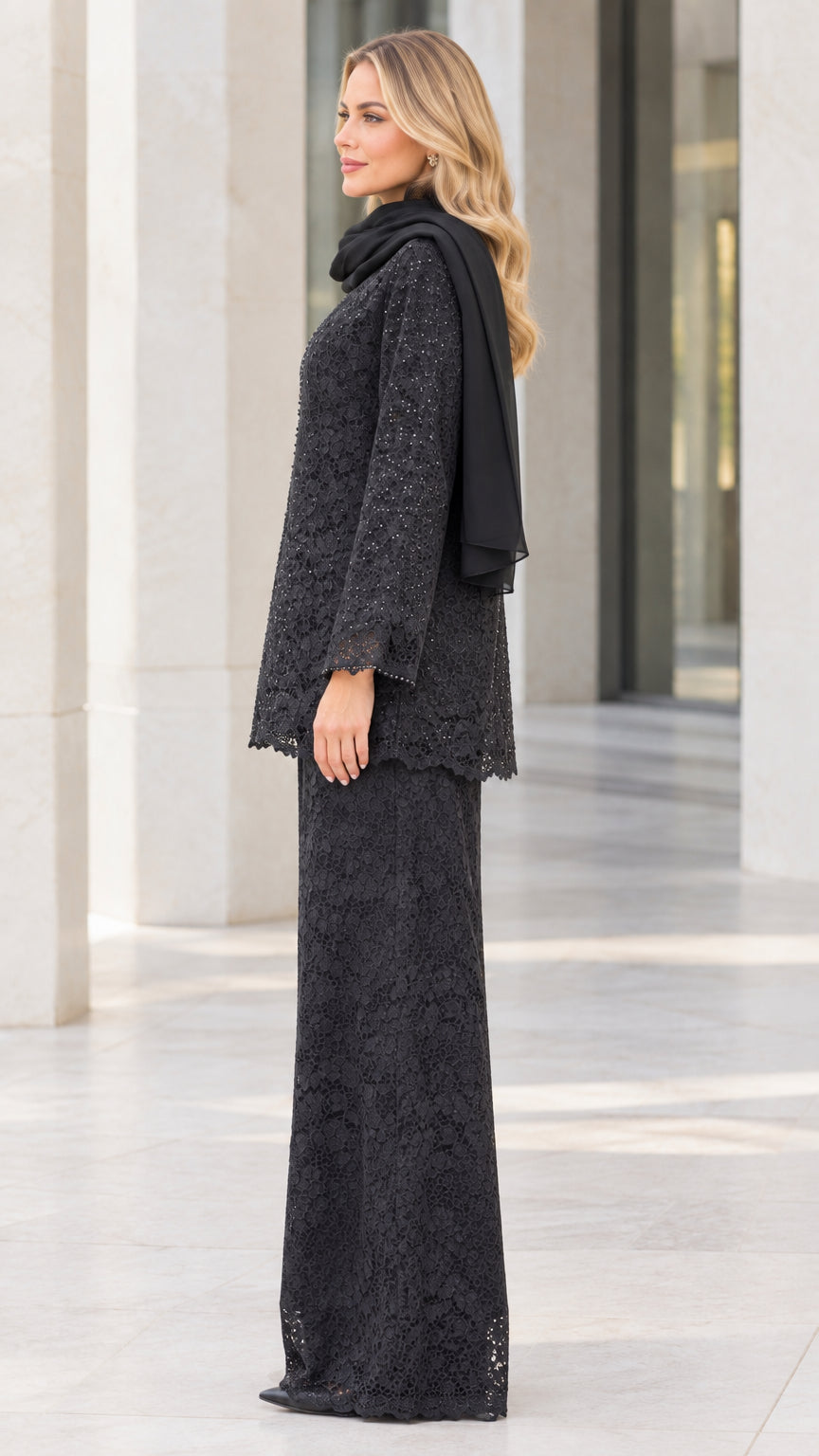 Side profile view of black lace pant suit ensemble with beaded cardigan and wide-leg trousers