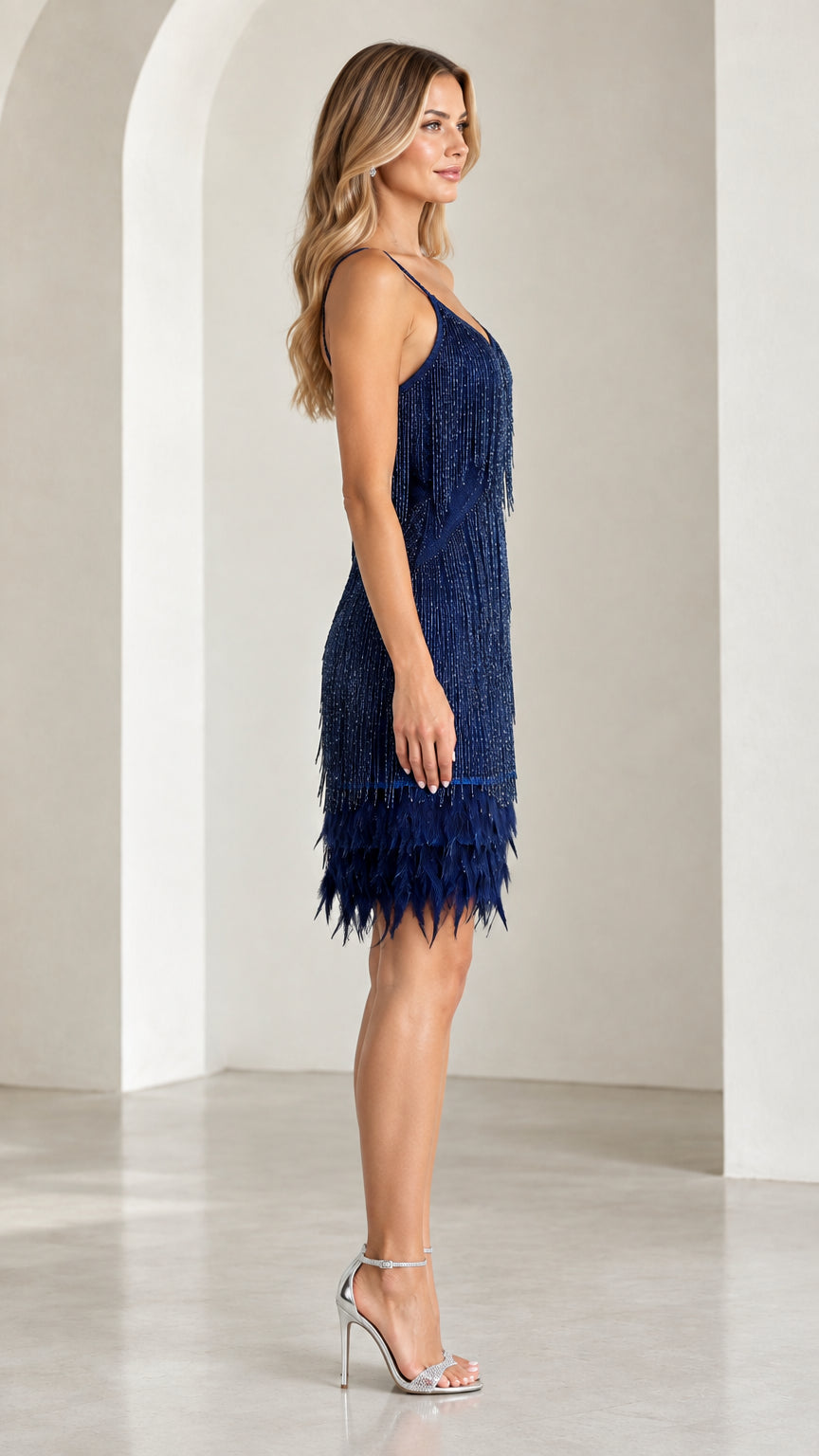 Side profile view of navy blue tassel flapper dress with feather hem