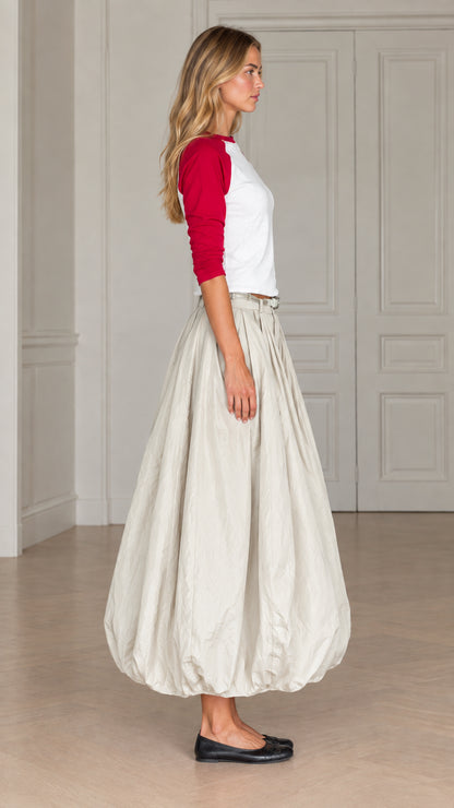Side profile view of women's balloon maxi skirt and raglan sleeve top in red and cream