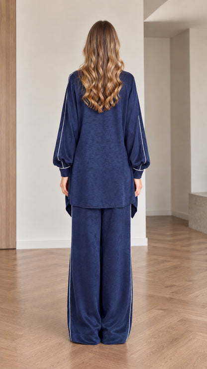 Back view of women wearing navy blue long-sleeve tunic and wide leg trousers set