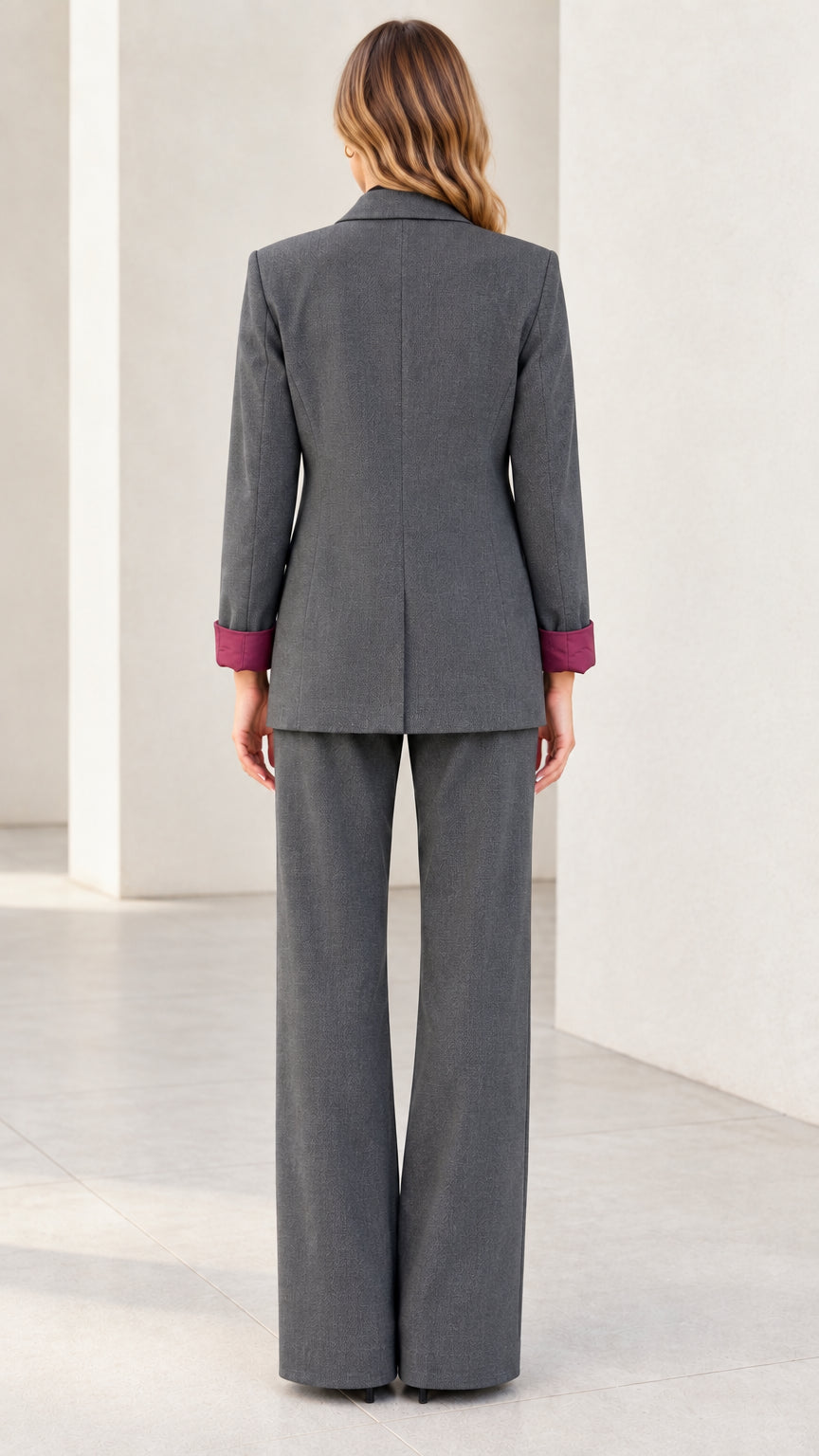 Back view of women's charcoal grey single-button blazer and matching pants