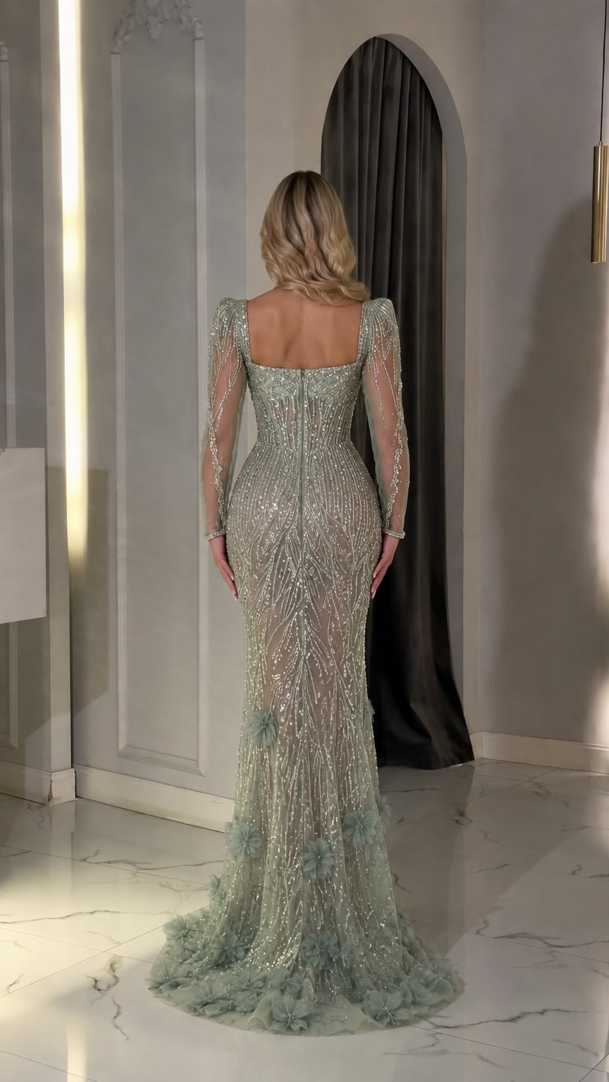 Back view of sage green long-sleeve evening gown showcasing fitted silhouette and sweep train