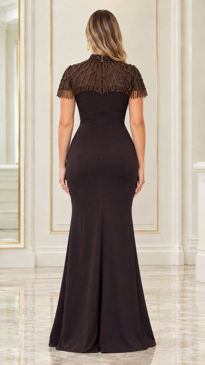 Back view of model wearing espresso formal dress with beaded capelet overlay