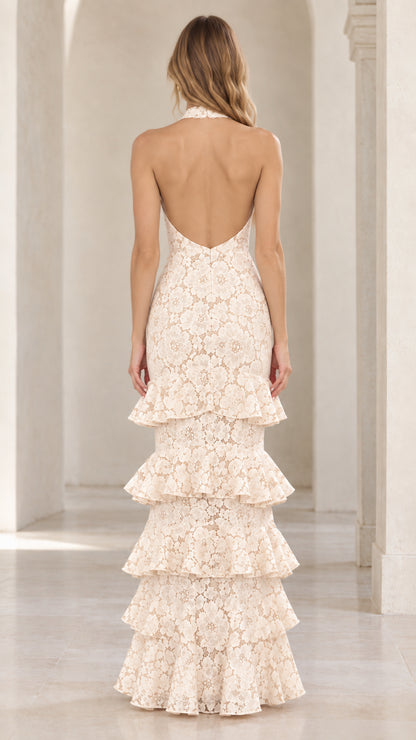 Back view of cream halter lace gown showing deep open back design and tiered skirt