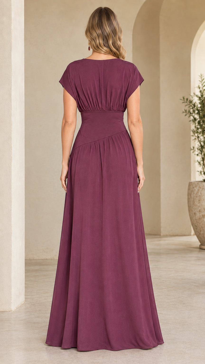 Back view of model showing gathered back detail of plum maxi gown