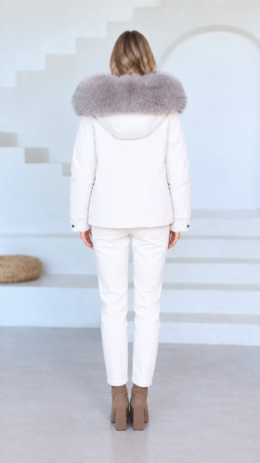 Back view of model wearing white hooded outerwear set
