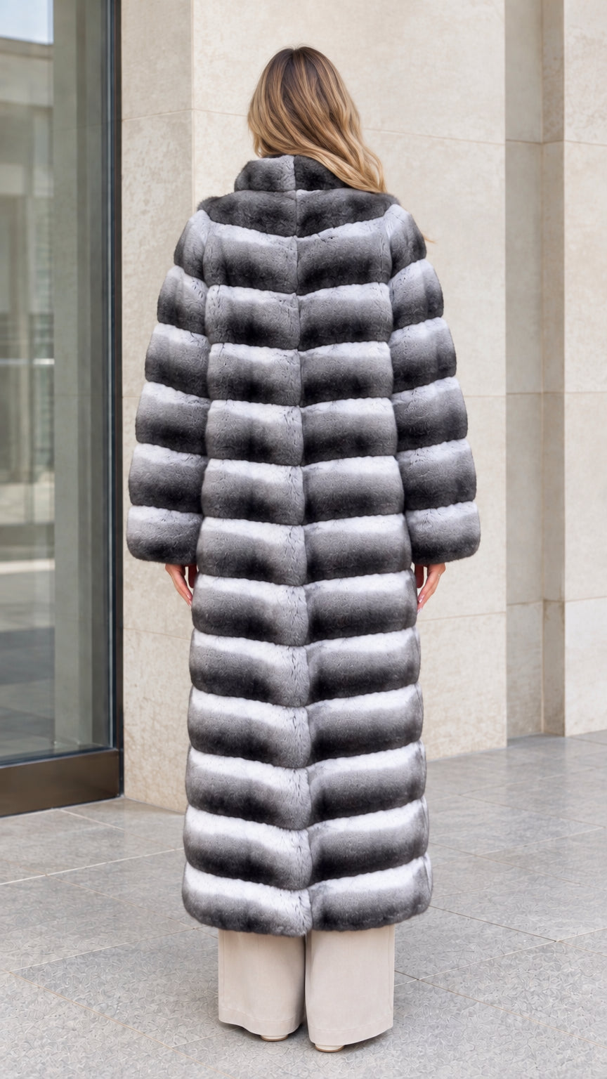 Back view of model showing full-length tiered construction of Grey Ombre faux fur coat