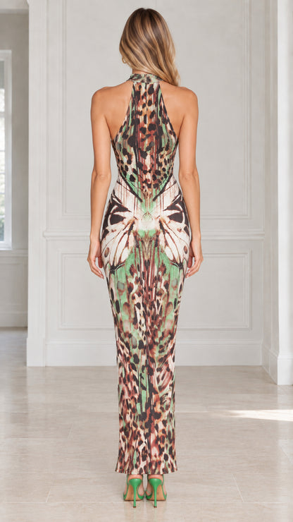 Back view of model showing open back and racerback halter neckline on maxi dress