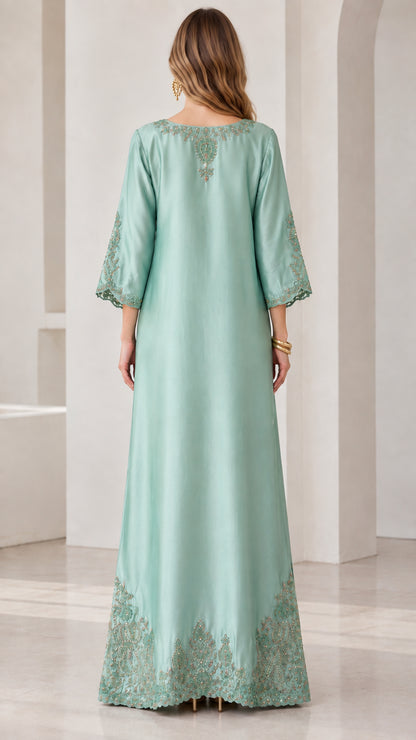 Back view of mint green embroidered maxi dress with neck embroidery