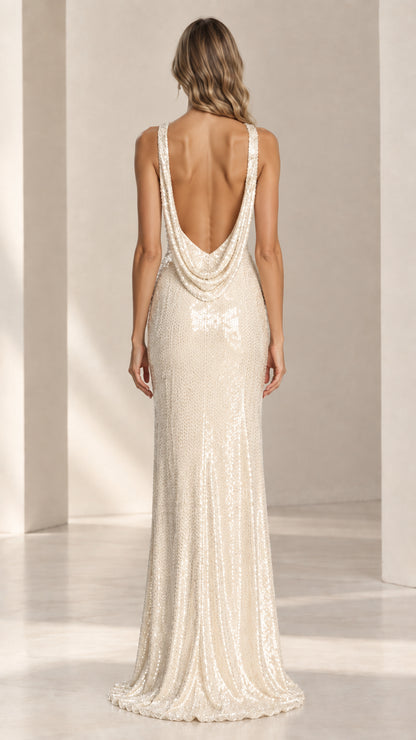 Back view of model in Champagne sequin dress showcasing open draped cowl back