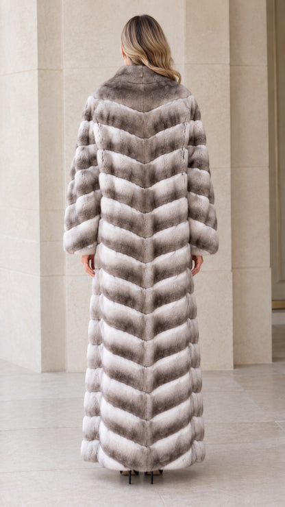 Back view of woman wearing chevron textured grey ombre maxi faux fur coat