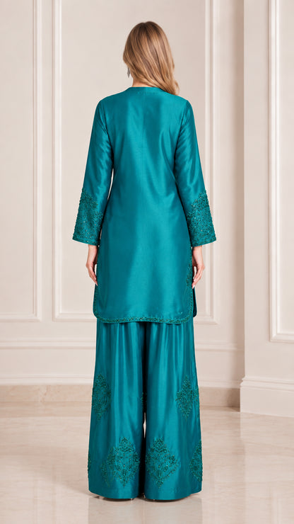 Teal satin two piece suit back view showing flowing silhouette