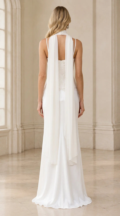 Back view of model wearing white formal dress showing flowing scarf tails