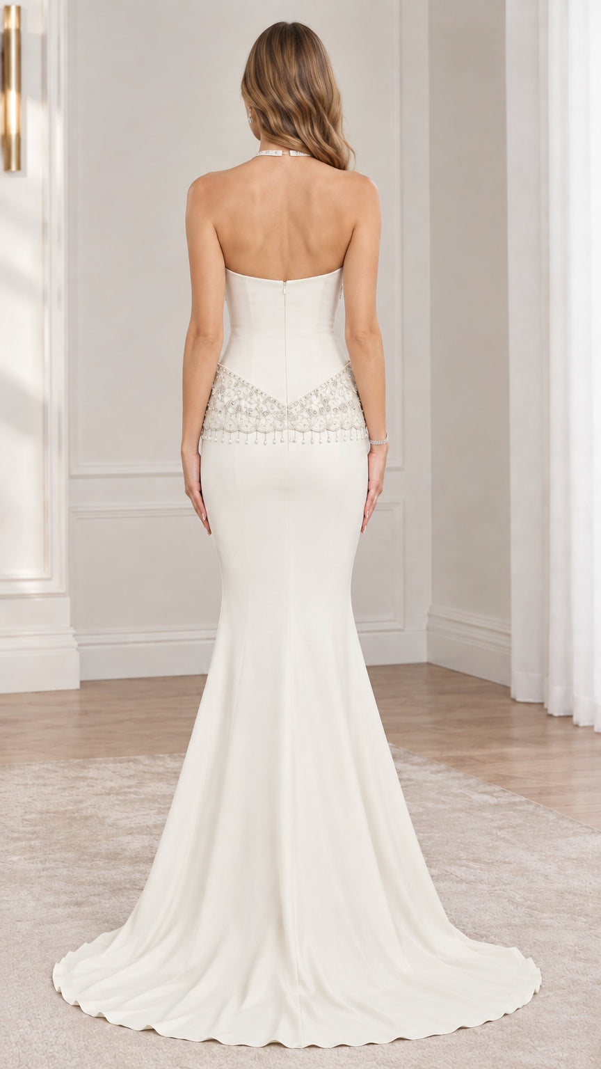 Back view of ivory beaded halter mermaid gown displaying open back design