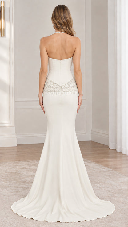 Back view of ivory beaded halter mermaid gown displaying open back design
