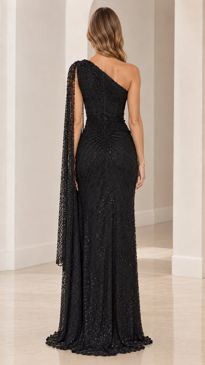 Back view of black sequin one-shoulder formal gown with floor-length hem