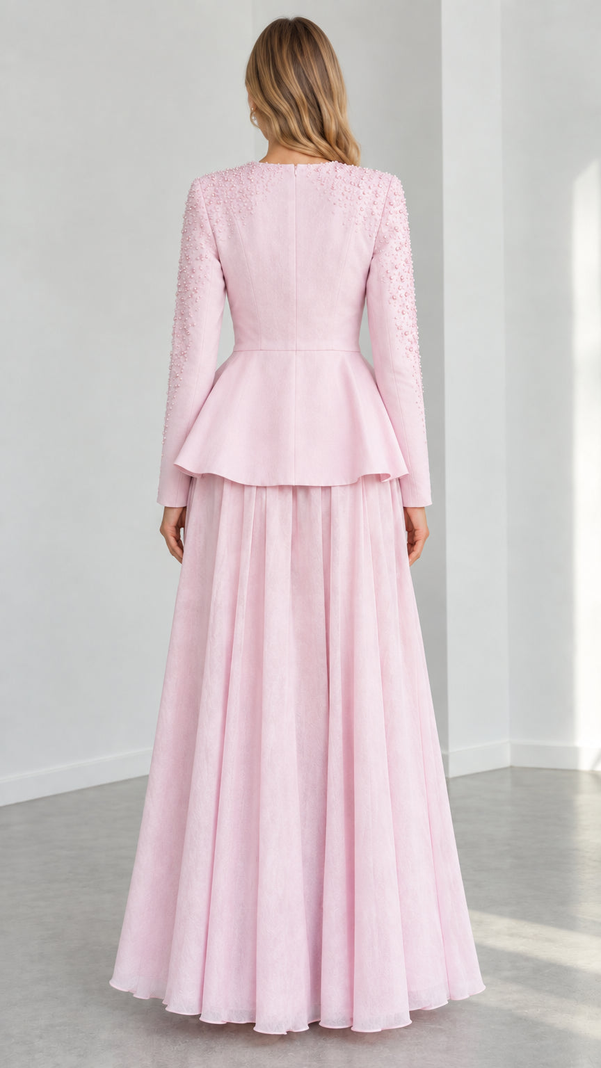 Blush Pink two-piece evening gown back view showing tailored peplum and pleated skirt