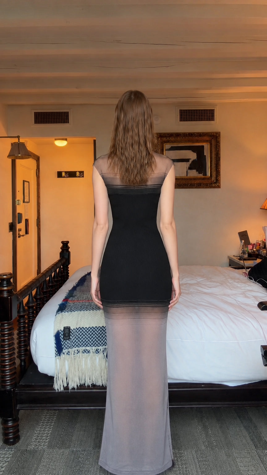 Back view of model wearing black sleeveless ribbed knit sheer hem maxi dress