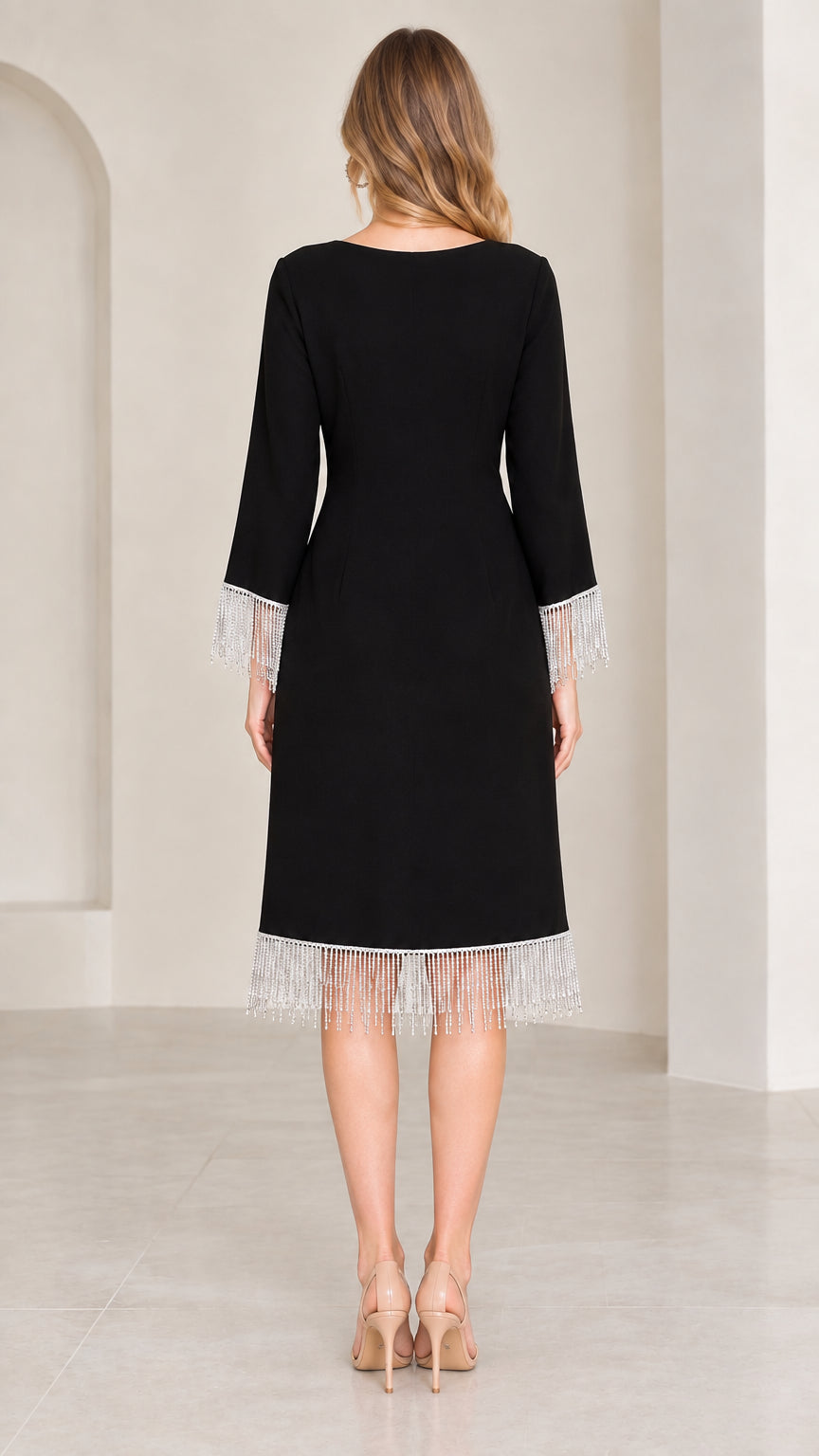 Back view of black knee-length cocktail dress with crystal tassel hem