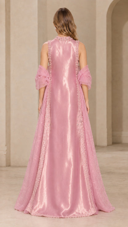 Back view of woman wearing blush pink sleeveless satin evening gown