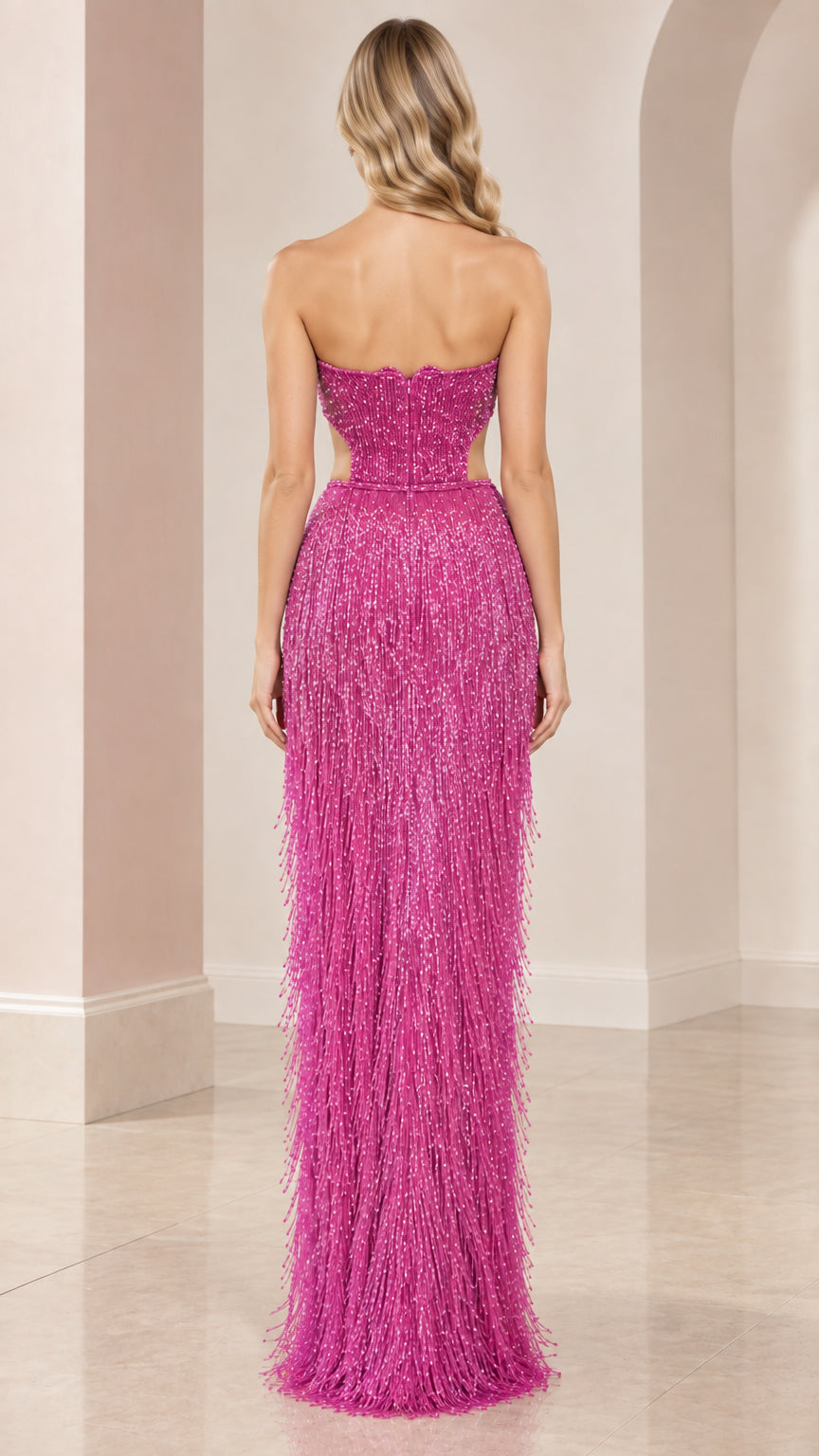 Back view of model in fuchsia strapless beaded fringe formal dress