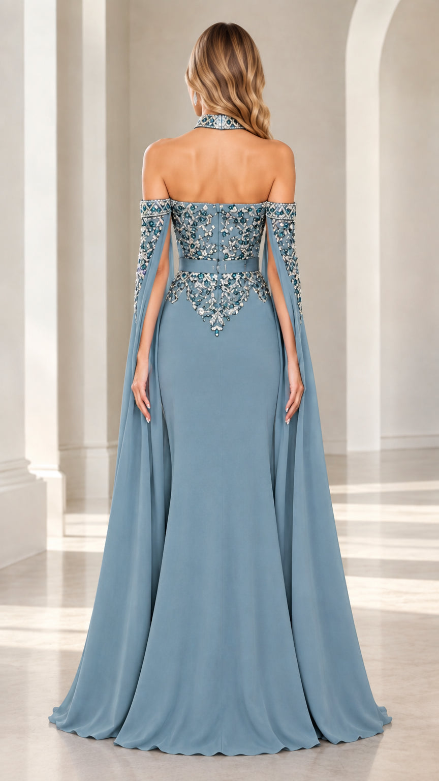 Back view of dusty blue halter evening gown showing dramatic cape drape