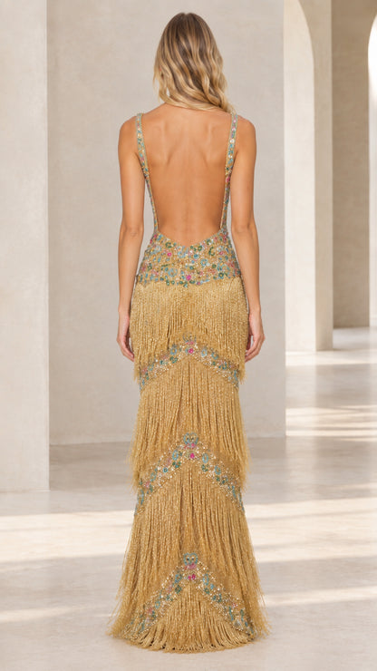Back view of gold fringe maxi gown showing open back silhouette