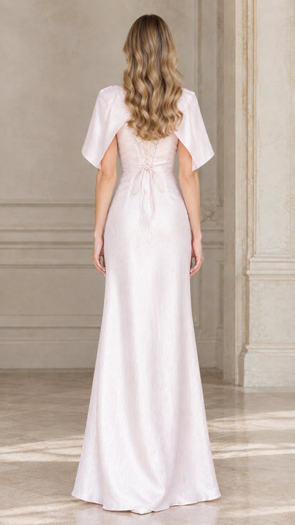 Back view of woman wearing blush pink maxi dress showing lace-up back detail