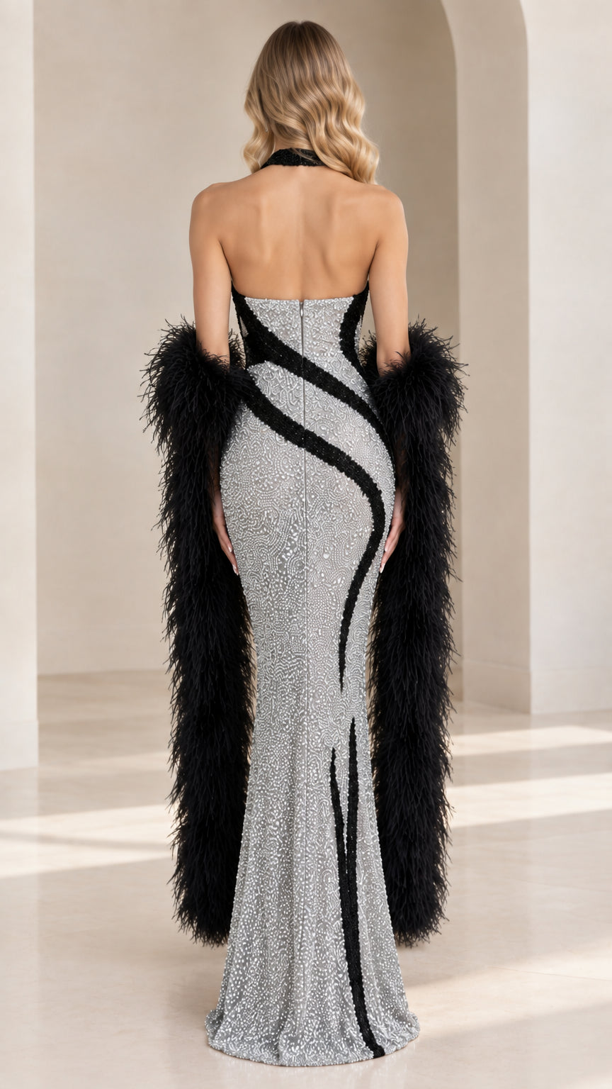 Back view of model in silver sequin halter dress showing open back design and contour lines